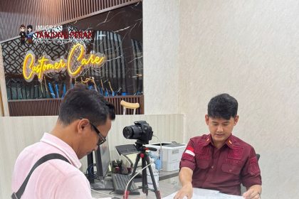 Petugas imigrasi ULP Kantor Imigrasi Tanjung Perak di Gresik melayani pemohon paspor di hari Minggu.